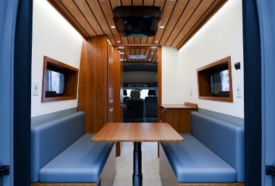 Opposing bench seats and a table inside a mobile behavioral health van